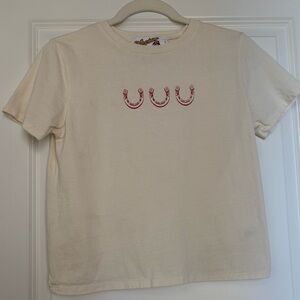 Stylish Cream Tee with Red Horseshoe Accents